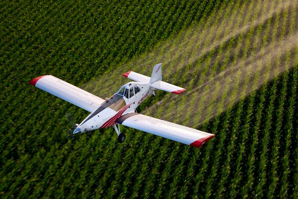 Some open fields are defoliated by planes.